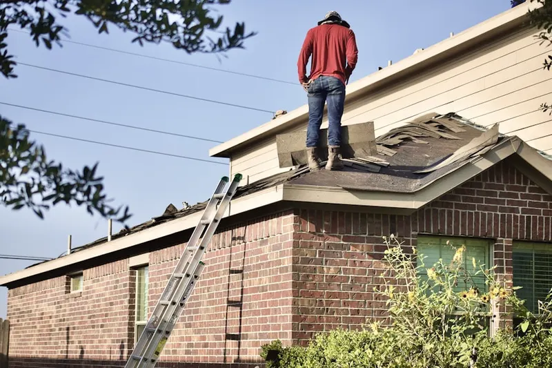 Professional roofer working on a residential roof in Brentwood Estates of Excel